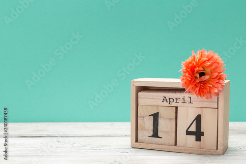 April 14th. Day 14 of april month, calendar on table with blue background. Spring time