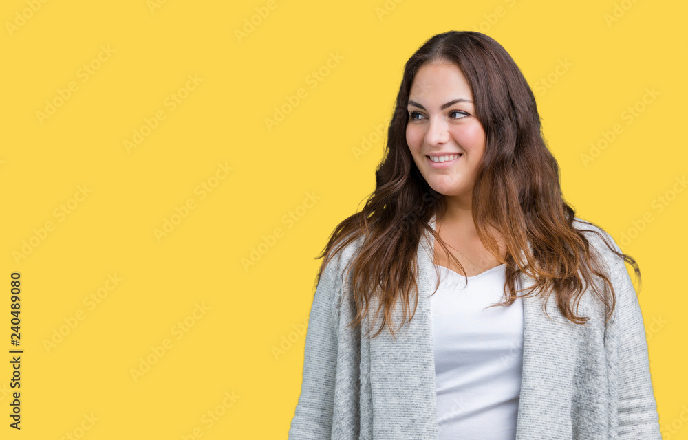 Beautiful plus size young woman wearing winter jacket over isolated background looking away to side with smile on face, natural expression. Laughing confident. Beautiful plus size young woman wearing winter jacket over isolated background looking away to side with smile on face, natural expression. Laughing confident.
