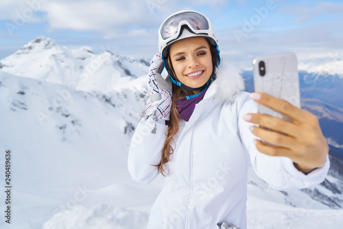 Young woman taking a selfie in winter holiday in mountain.