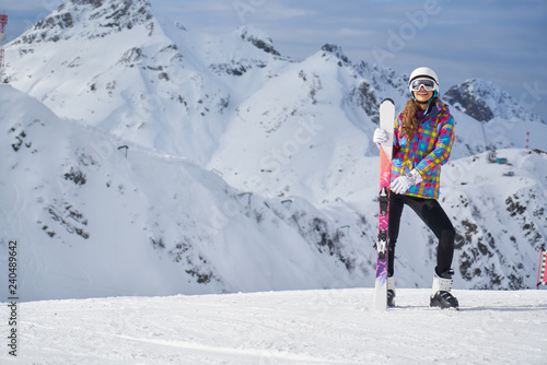 Portrait of woman in ski outfit. Portrait of cheerful blond woman at ski resort