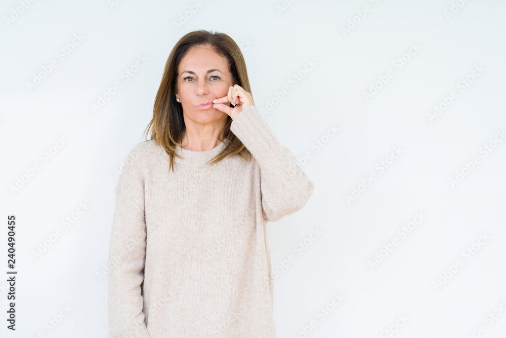 Beautiful middle age woman over isolated background mouth and lips shut as zip with fingers. Secret and silent, taboo talking Beautiful middle age woman over isolated background mouth and lips shut as zip with fingers. Secret and silent, taboo talking