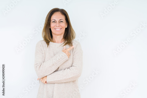 Beautiful middle age woman over isolated background cheerful with a smile of face pointing with hand and finger up to the side with happy and natural expression on face