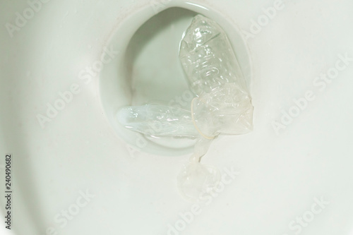 Condom on pan in toilet. garbage concept © Вячеслав Козырев