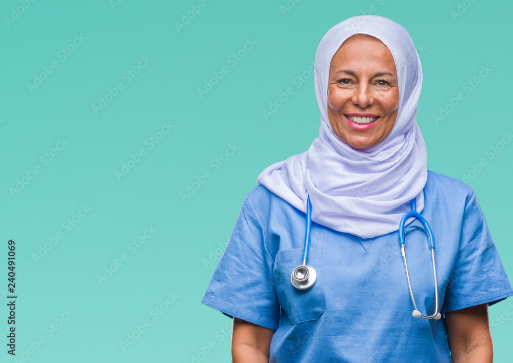Middle age senior arab nurse woman wearing hijab over isolated background with a happy and cool smile on face. Lucky person. Middle age senior arab nurse woman wearing hijab over isolated background with a happy and cool smile on face. Lucky person.