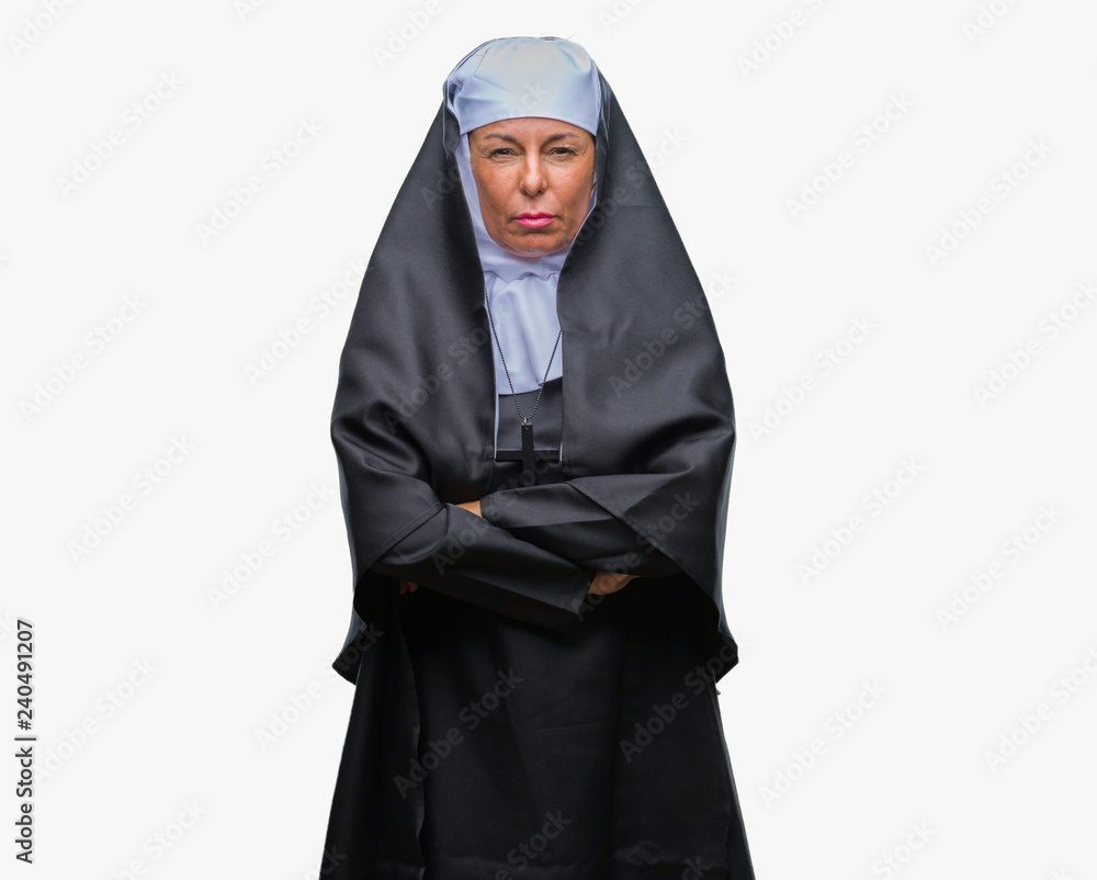 Middle age senior christian catholic nun woman over isolated background skeptic and nervous, disapproving expression on face with crossed arms. Negative person. Middle age senior christian catholic nun woman over isolated background skeptic and nervous, disapproving expression on face with crossed arms. Negative person.