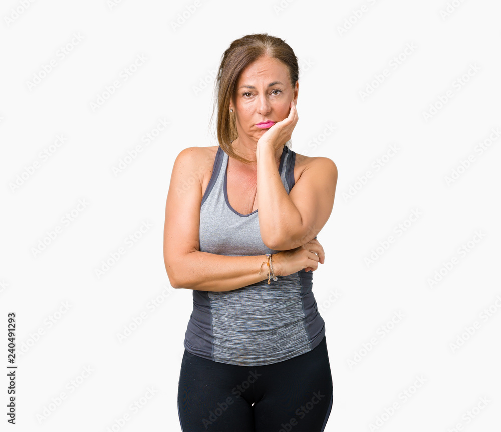 Beautiful middle age woman wearing sport clothes over isolated background thinking looking tired and bored with depression problems with crossed arms. Beautiful middle age woman wearing sport clothes over isolated background thinking looking tired and bored with depression problems with crossed arms.
