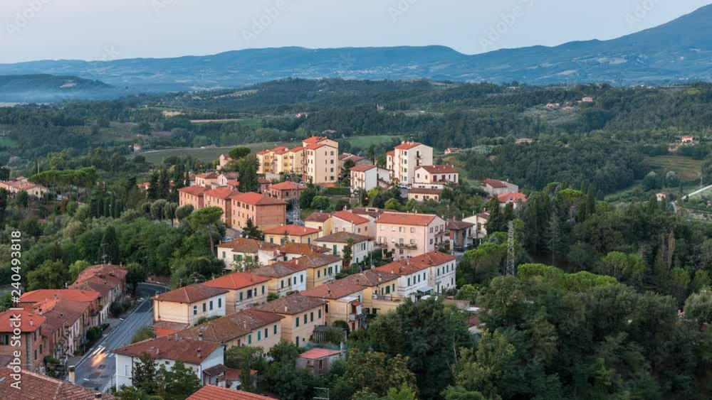 Timelapse, time lapse of Historic Italian town village in Chiusi, Umbria, Italy cityscape with high angle view of colorful architecture old buildings during sunrise dawn Timelapse, time lapse of Historic Italian town village in Chiusi, Umbria, Italy cityscape with high angle view of colorful architecture old buildings during sunrise dawn
