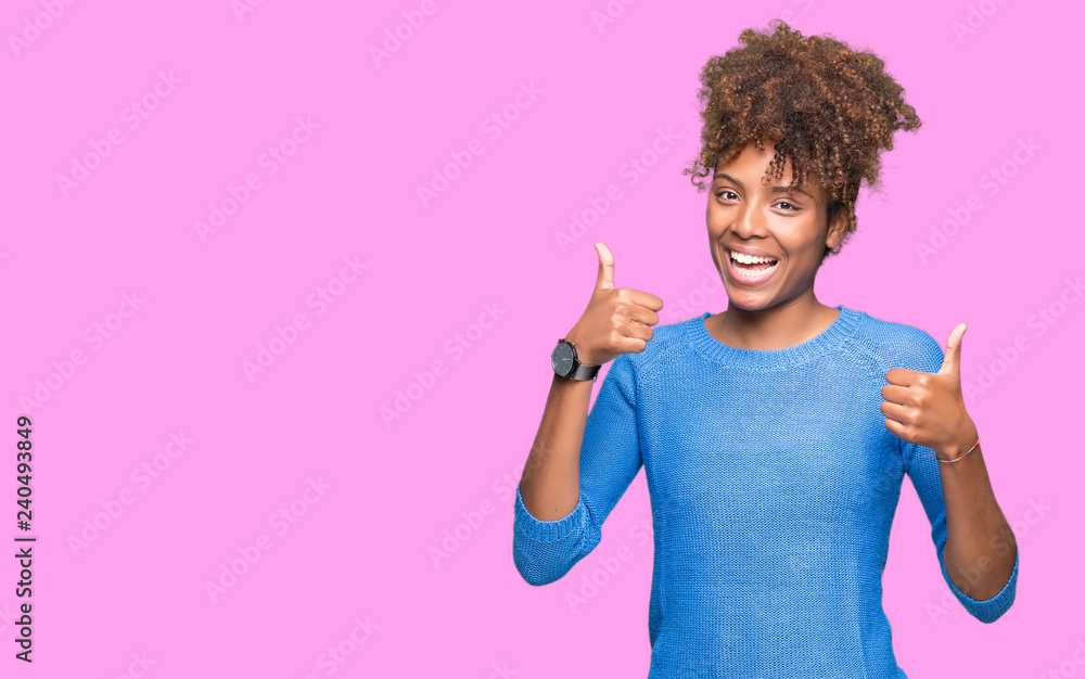 Beautiful young african american woman over isolated background success sign doing positive gesture with hand, thumbs up smiling and happy. Looking at the camera with cheerful expression Beautiful young african american woman over isolated background success sign doing positive gesture with hand, thumbs up smiling and happy. Looking at the camera with cheerful expression