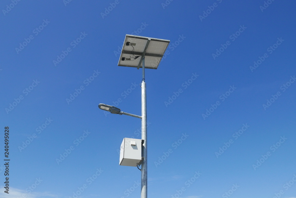 Close up view of LED street light with solar cell on clear blue sky background with clouds. Close up view of LED street light with solar cell on clear blue sky background with clouds.