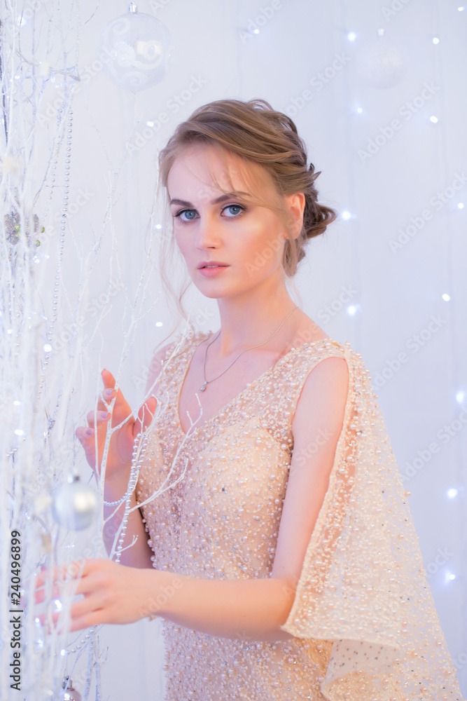 portrait of a young beautiful woman on the background with lights. New Year and Christmas themes portrait of a young beautiful woman on the background with lights. New Year and Christmas themes