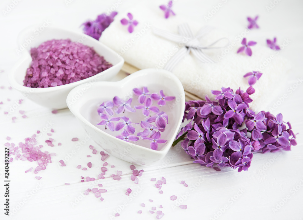 Spa towel and massage products with lilac flowers Spa towel and massage products with lilac flowers