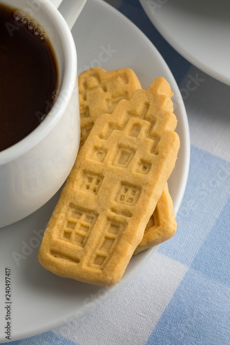 Cup of coffee with butter cookies in the shape of Dutch canal houses