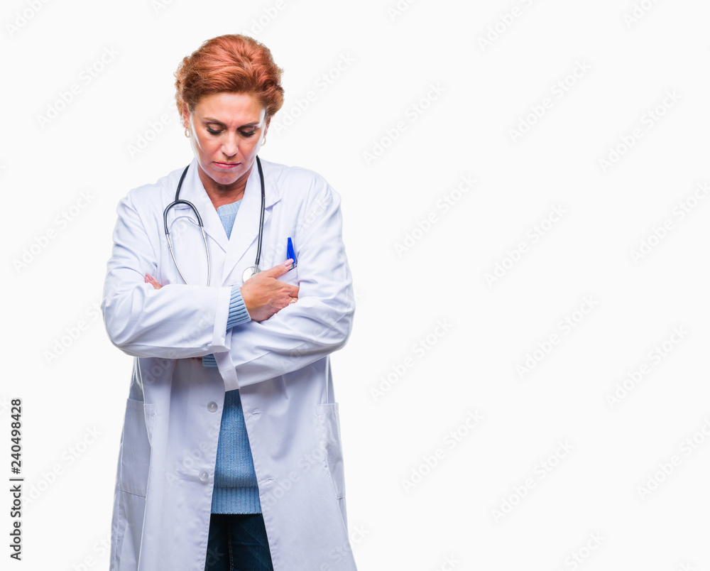 Senior caucasian doctor woman wearing medical uniform over isolated background skeptic and nervous, disapproving expression on face with crossed arms. Negative person. Senior caucasian doctor woman wearing medical uniform over isolated background skeptic and nervous, disapproving expression on face with crossed arms. Negative person.