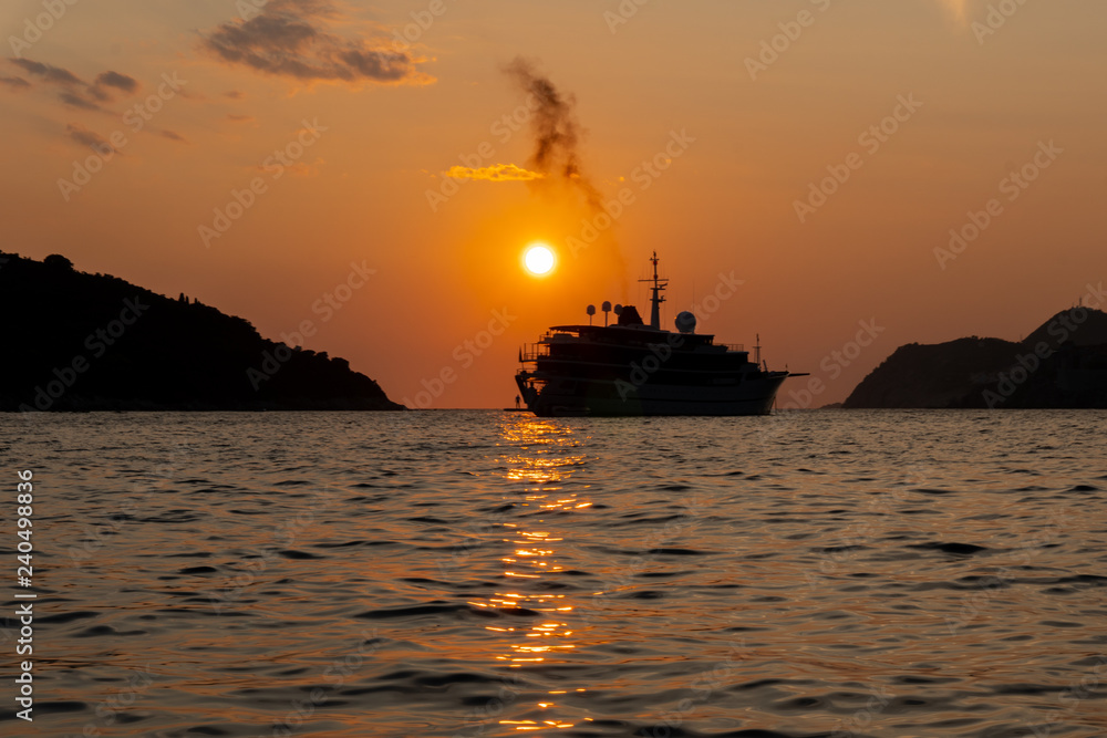 silhouette of a ship during golden sunset