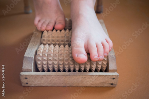 baby feet on wooden massager