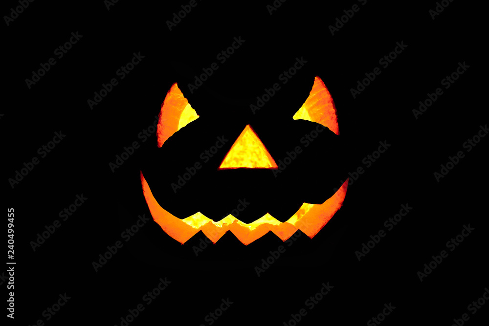 Glowing scary face made of pumpkin on black background. Halloween Glowing scary face made of pumpkin on black background. Halloween