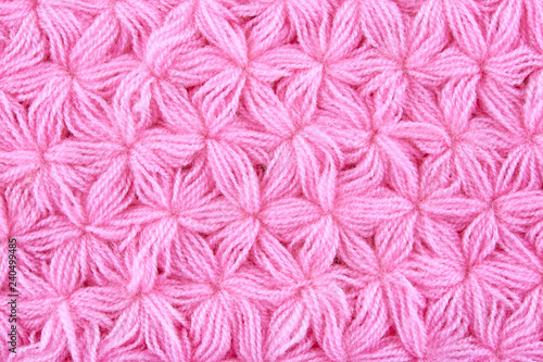 Pink woolen texture background. Macro of knitted cloth