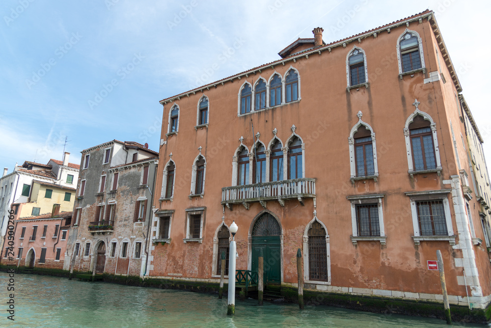 Gondola passing by multicolored buildings