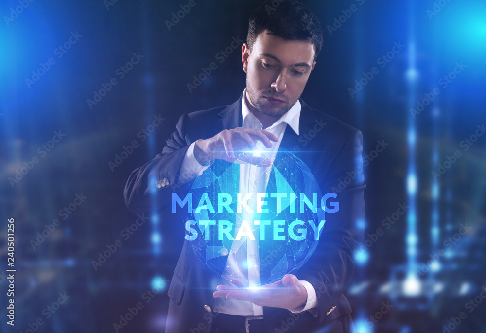 The concept of business, technology, the Internet and the network. A young entrepreneur working on a virtual screen of the future and sees the inscription: marketing strategy The concept of business, technology, the Internet and the network. A young entrepreneur working on a virtual screen of the future and sees the inscription: marketing strategy