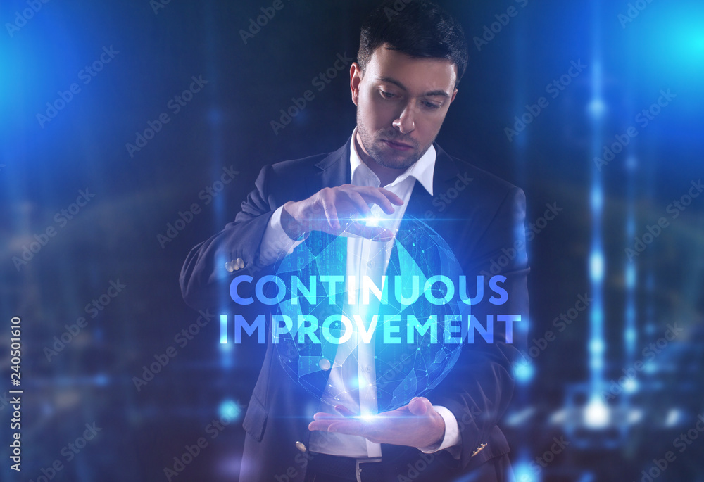 The concept of business, technology, the Internet and the network. A young entrepreneur working on a virtual screen of the future and sees the inscription: Continuous improvement The concept of business, technology, the Internet and the network. A young entrepreneur working on a virtual screen of the future and sees the inscription: Continuous improvement