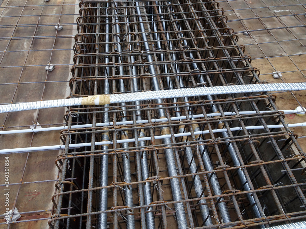 Pre-stress cable laid in round ducting and install in between the slab steel reinforcement bar at the construction site.   
