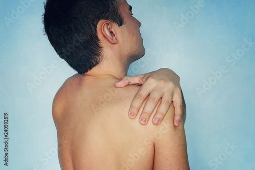 Fotografi people, healthcare and problem concept - unhappy man suffering from neck or shoulder pain at home