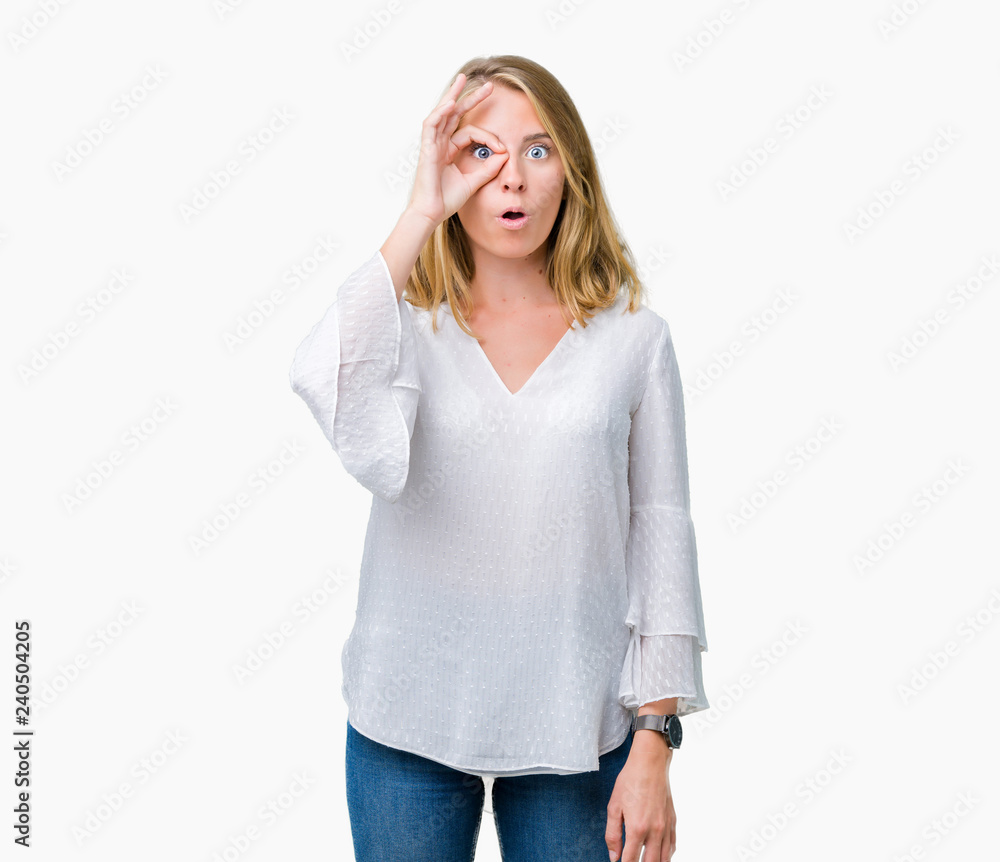 Beautiful young elegant woman over isolated background doing ok gesture shocked with surprised face, eye looking through fingers. Unbelieving expression. Beautiful young elegant woman over isolated background doing ok gesture shocked with surprised face, eye looking through fingers. Unbelieving expression.