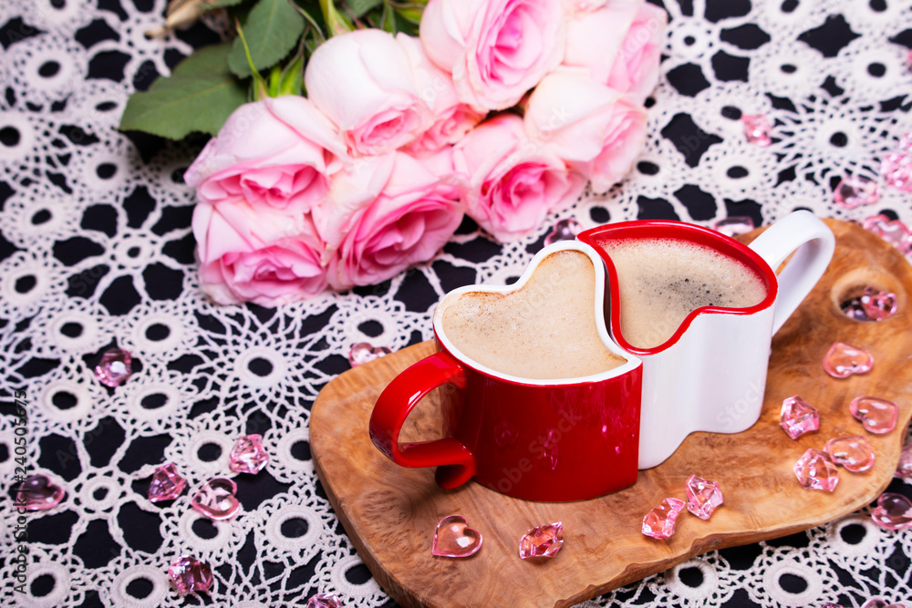 Red and white heart shaped coffee cups next to pink roses, black love sign  and scattered pink glass hearts Stock Photo | Adobe Stock