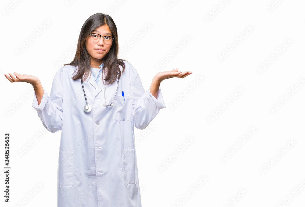 Young asian doctor woman over isolated background clueless and confused expression with arms and hands raised. Doubt concept. Young asian doctor woman over isolated background clueless and confused expression with arms and hands raised. Doubt concept.