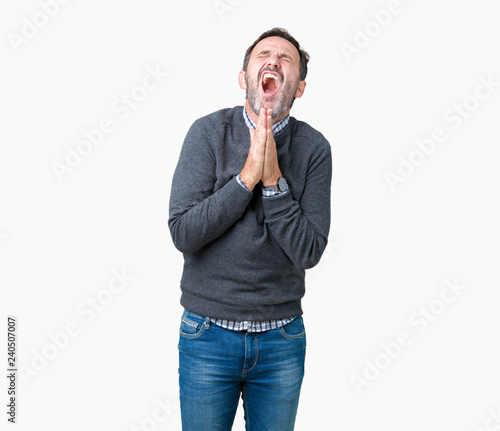 Handsome middle age senior man wearing a sweater over isolated background begging and praying with hands together with hope expression on face very emotional and worried. Asking for forgiveness