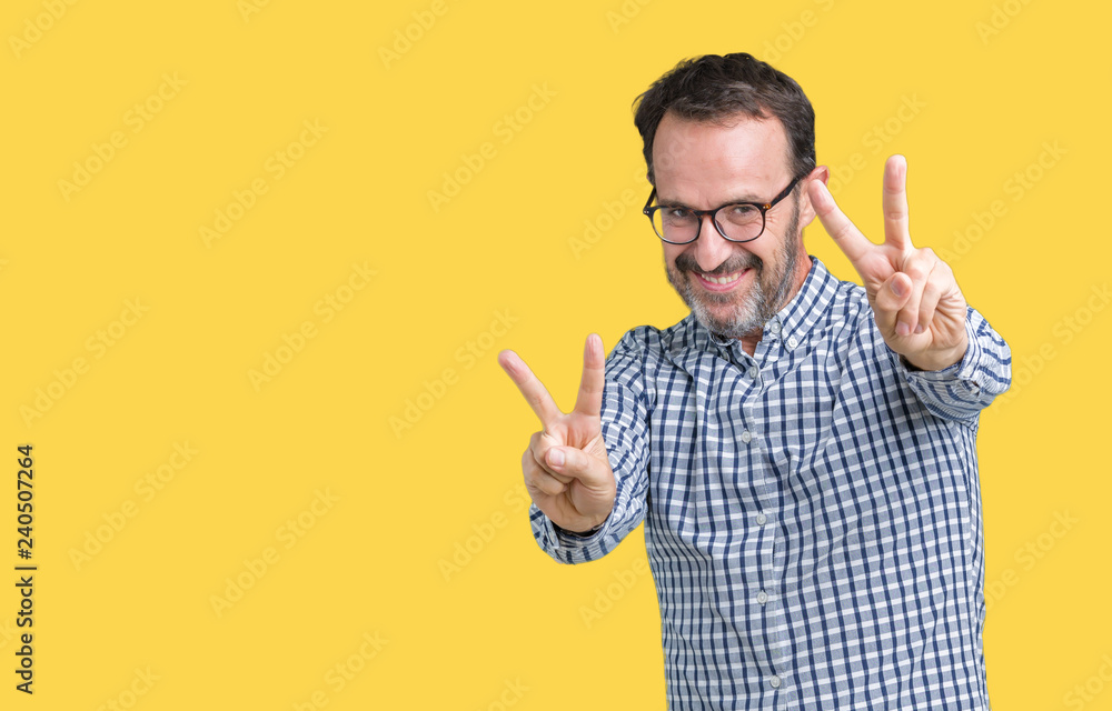 Handsome middle age elegant senior business man wearing glasses over isolated background smiling looking to the camera showing fingers doing victory sign. Number two. Handsome middle age elegant senior business man wearing glasses over isolated background smiling looking to the camera showing fingers doing victory sign. Number two.