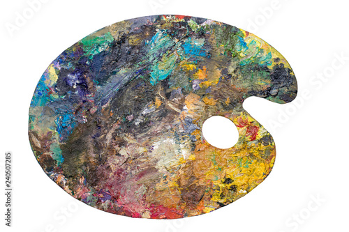 Wooden art palette with blobs of paint on white  isolated background