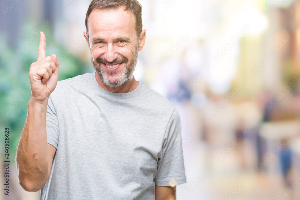 Middle age senior hoary man over isolated background pointing finger up with successful idea. Exited and happy. Number one. Middle age senior hoary man over isolated background pointing finger up with successful idea. Exited and happy. Number one.