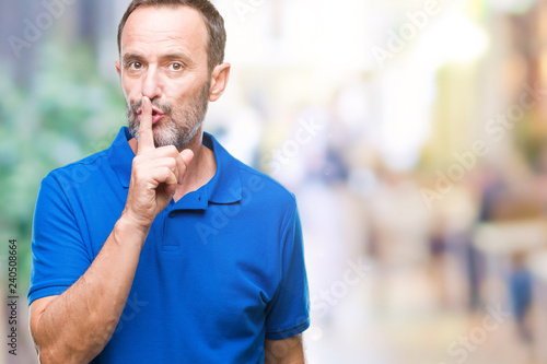 Middle age hoary senior man over isolated background asking to be quiet with finger on lips. Silence and secret concept.