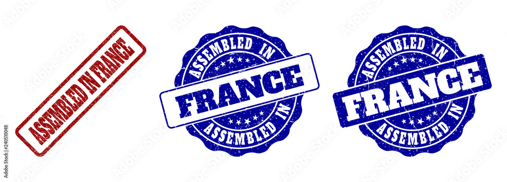 ASSEMBLED IN FRANCE scratched stamp seals in red and blue colors. Vector ASSEMBLED IN FRANCE signs with dirty effect. Graphic elements are rounded rectangles, rosettes, circles and text labels.