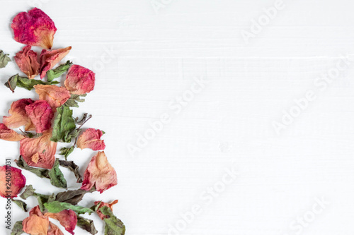 Fototapeta Naklejka Na Ścianę i Meble -  Background with dried leaves and rose petals. Concept with dried rose petals. Photo above. Frame for greeting card with dried rose petals and leaves. Frame for the banner on the site with flowers