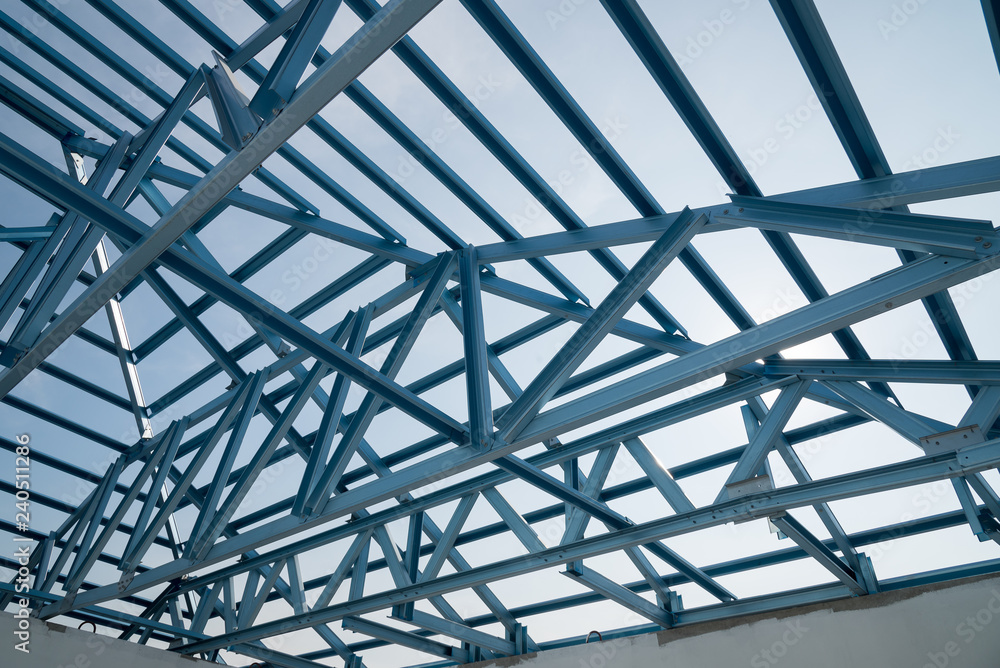 Fototapeta premium Structure of steel roof frame for building construction.