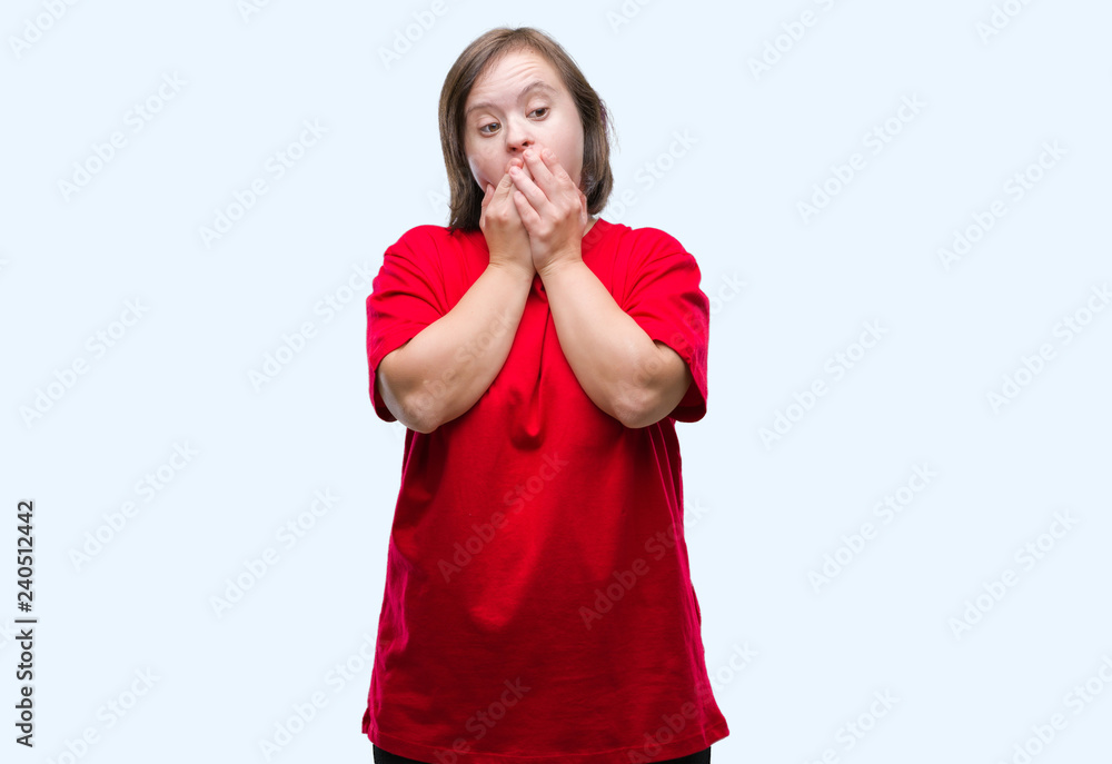 Young adult woman with down syndrome over isolated background shocked covering mouth with hands for mistake. Secret concept. Young adult woman with down syndrome over isolated background shocked covering mouth with hands for mistake. Secret concept.