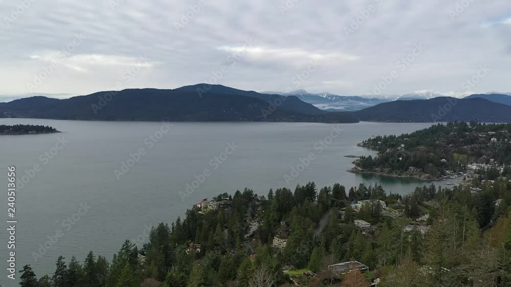 Aerial view over Burrard Inlet, ocean and island with boat and mountains in beautiful British Columbia. Canada. Aerial view over Burrard Inlet, ocean and island with boat and mountains in beautiful British Columbia. Canada.