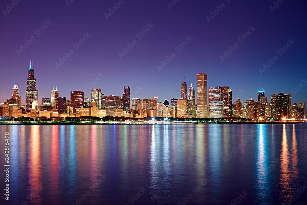 Chicago Skyline at Night with skyscraper reflections in Lake Michigan