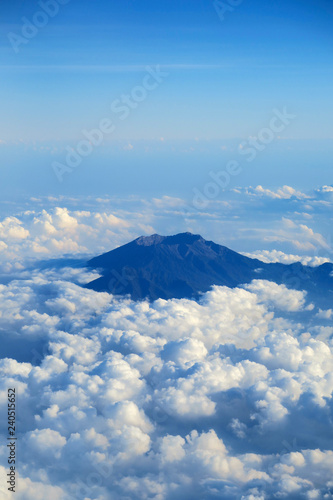 Mountain peak in clouds, aerial view from plane window © art_of_sun