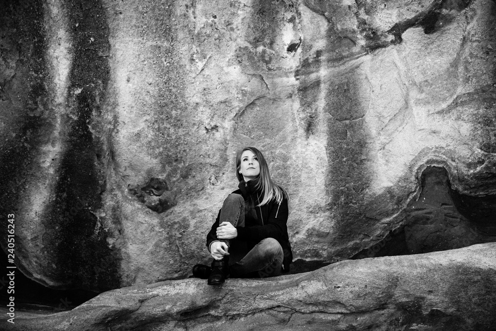 Black and White Portrait of Beautiful Attractive Young Modern Fashion Adult Model in Front of Natural Old Ancient Stone Red Rock Wall Background
