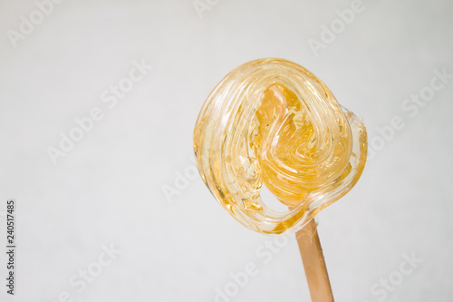 sugar paste or wax honey for hair removing with wooden waxing spatula sticks - depilation and beauty concept photo