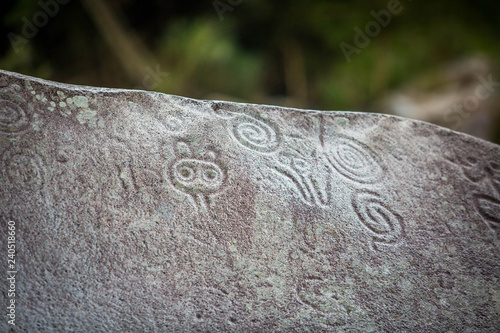 Ancient carved figures on stones in Jayuya Puerto Rico photo