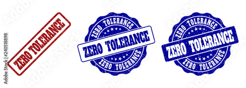 ZERO TOLERANCE grunge stamp seals in red and blue colors. Vector ZERO TOLERANCE labels with distress style. Graphic elements are rounded rectangles, rosettes, circles and text labels.