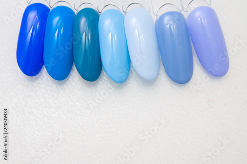 Nail Care And Manicure concept. Blue Multicolor Nail Polish palette for Client s Nails choise. Woman In Beauty Salon. Copyspace for text