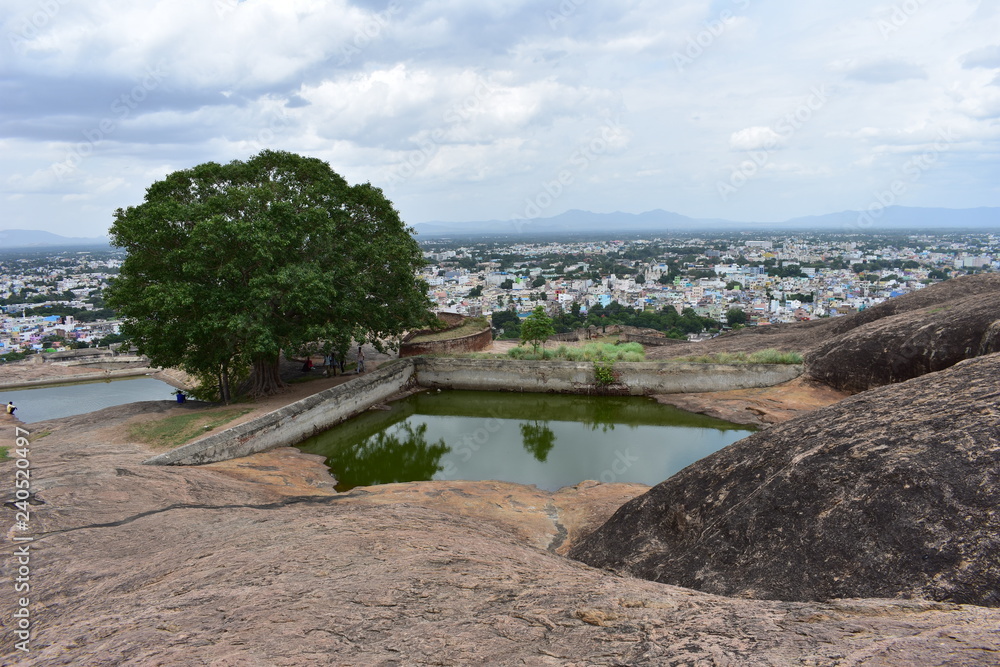 Dindigul, Tamilnadu, India - July 13, 2018: Pond and cave in Dindigul Rock Fort