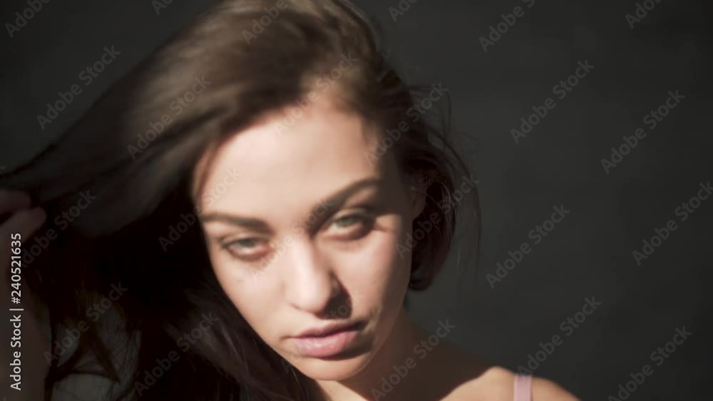 Portrait of a beautiful woman untying long brown hair. Portrait of a beautiful woman untying long brown hair.