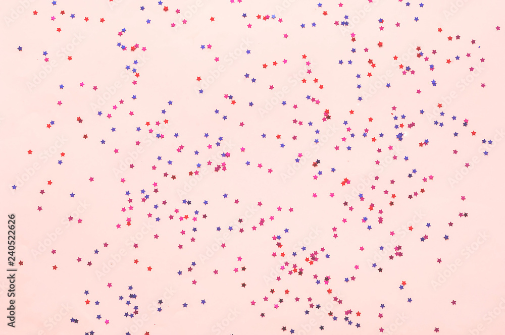 Confetti and stars on pink pastel trendy background. Festive bac