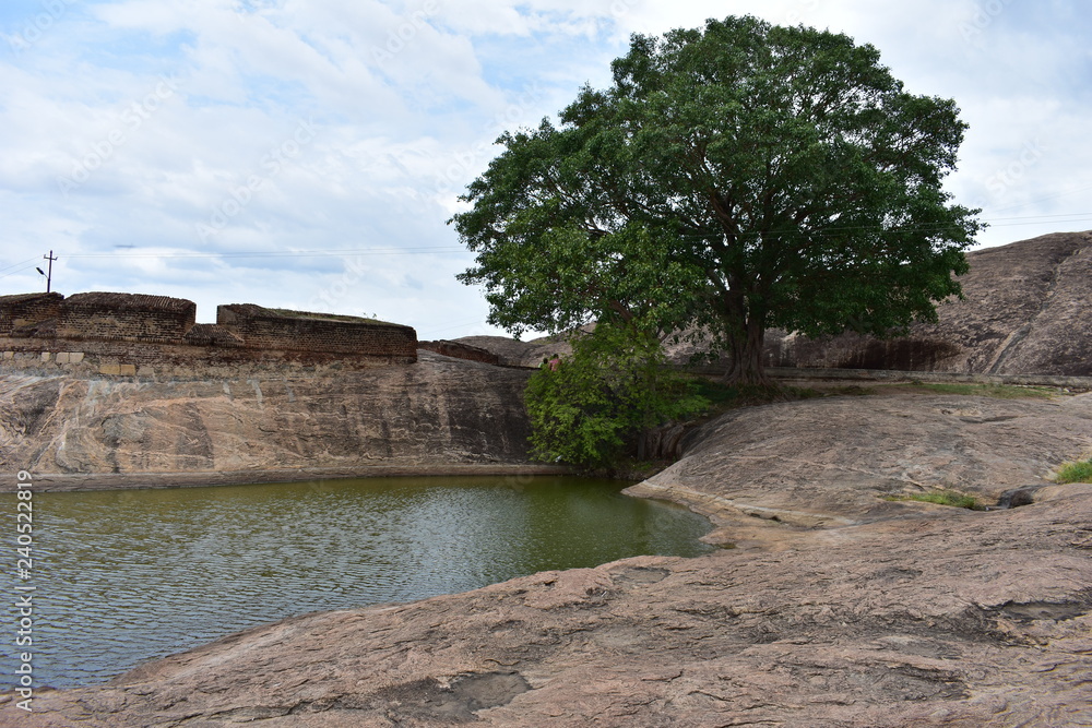 Dindigul, Tamilnadu, India - July 13, 2018: Pond and cave in Dindigul Rock Fort Dindigul, Tamilnadu, India - July 13, 2018: Pond and cave in Dindigul Rock Fort
